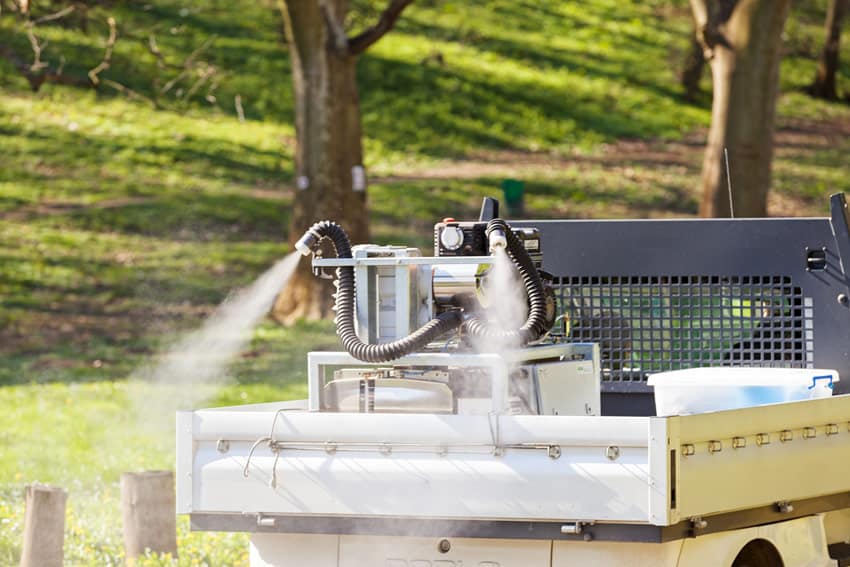 truck spraying fog to kill mosquitos